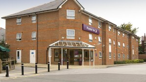 A brick building with a glass entrance and a sign for Premier Inn. - Premier Inn Leeds East (Leeds)