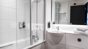 A modern bathroom with a glass shower enclosure, a white sink, and a large mirror. - ibis Coleraine Riverside (Coleraine)