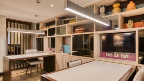 A modern room with a desk, chair, and shelves containing various items.