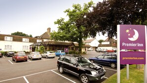 A parking lot with cars, a sign for Premier Inn, and buildings in the background. - Premier Inn Gatwick Crawley - Goff's Park (Crawley)