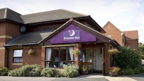 A brick building with a purple awning labeled 'Premier Inn.' - Premier Inn Thurrock East (Grays)
