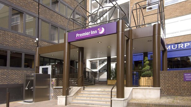 A hotel entrance with a sign for Premier Inn, a staircase, and a car park sign. - Premier Inn Brentwood (Brentwood)