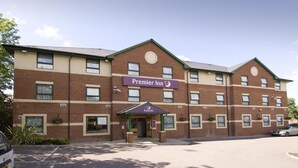 A multi-story hotel with a prominent 'Premier Inn' sign, a brick facade, and a parking lot. - Premier Inn Watford North (Watford)
