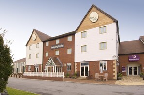 A hotel with a 'Swinging Bridge' sign, a 'Table Table' sign, and a 'Premier Inn' sign. - Premier Inn Manchester Trafford Centre Nth (Manchester)