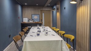 A conference room with a long table, yellow chairs, and a white tablecloth. - Plaza Hotel, Chorley, Sure Collection by Best Western (Chorley)