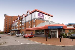 A hotel with a prominent Premier Inn sign, a Watersreach restaurant, and multiple parking spaces.