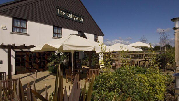 A building named 'The Callwith' with outdoor seating and umbrellas. - Premier Inn Bodmin (Bodmin)