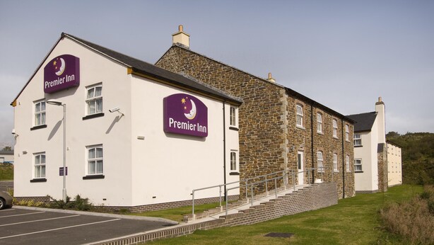 A two-story building with a stone facade and a white exterior. There are two prominent signs on the building that read 'Premier Inn.' - Premier Inn St. Austell (St Austell)