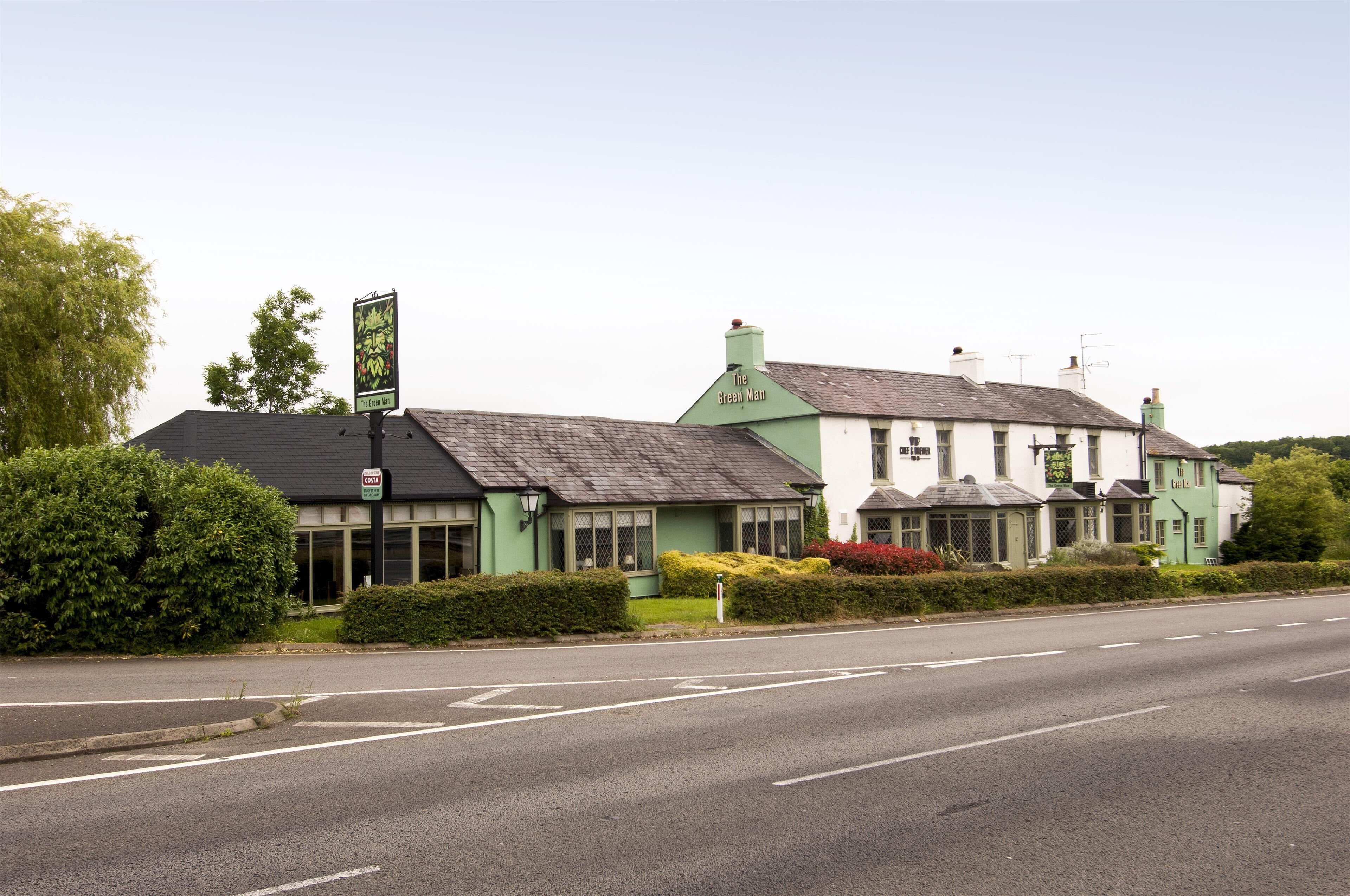 A green building with a sign reading 'The Green Man.'