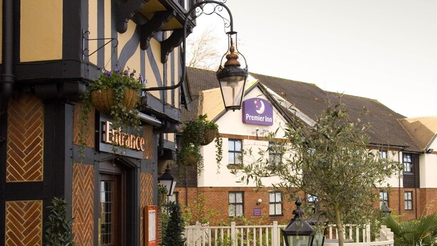 Een klassiek gebouw met een bord waarop 'Entree' staat en een 'Premier Inn' bord boven de ingang.