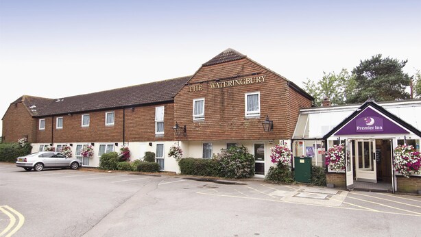 A two-story building with a sign reading 'The Wateringbury.'