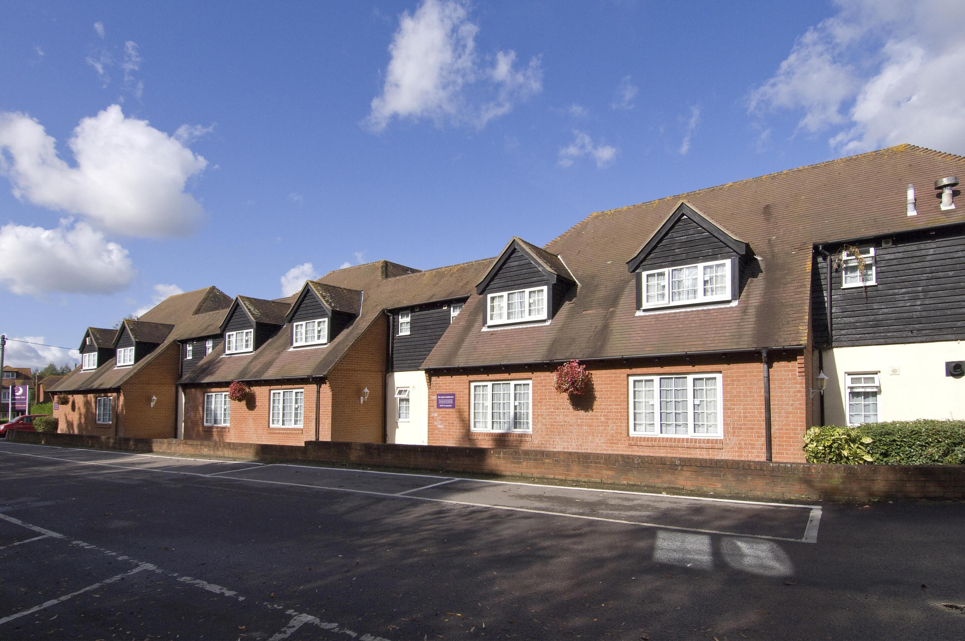 A row of residential houses with pitched roofs and brick exteriors.