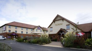 A hotel with a prominent entrance, a parking area, and a sign for 'The Fairer.' - Premier Inn Grantham (Grantham)