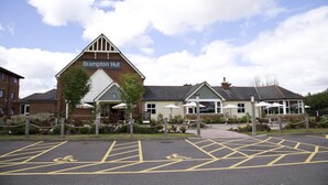 A hotel named Brampton Hut with a parking area marked for disabled access. - Premier Inn Huntingdon - A1/A14 (Huntingdon)