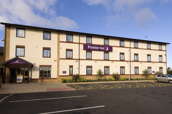Premier Inn features a flat facade with evenly spaced windows and a prominent sign above the entrance.