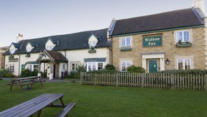 A traditional building with a sign reading 'Walton Fox.'