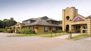 A hotel with a prominent tower, a brick facade, and a sign for the Premier Inn. - Premier Inn Aldershot (Aldershot)