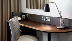 A modern hotel desk with a leather chair, a lamp, and a power outlet. - Premier Inn Lancaster (Lancaster)