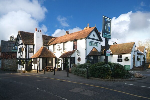Experience the charm of The Old Bell, a traditional English pub with Tudor-style architecture.