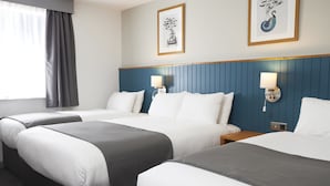 A hotel room with three beds, each with white and gray bedding, a blue headboard, and two wall-mounted lamps. - Holmfield Arms By Greene King Inns (Wakefield)