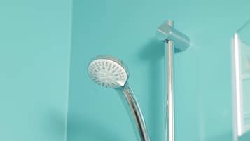 A chrome showerhead attached to a wall-mounted handle.