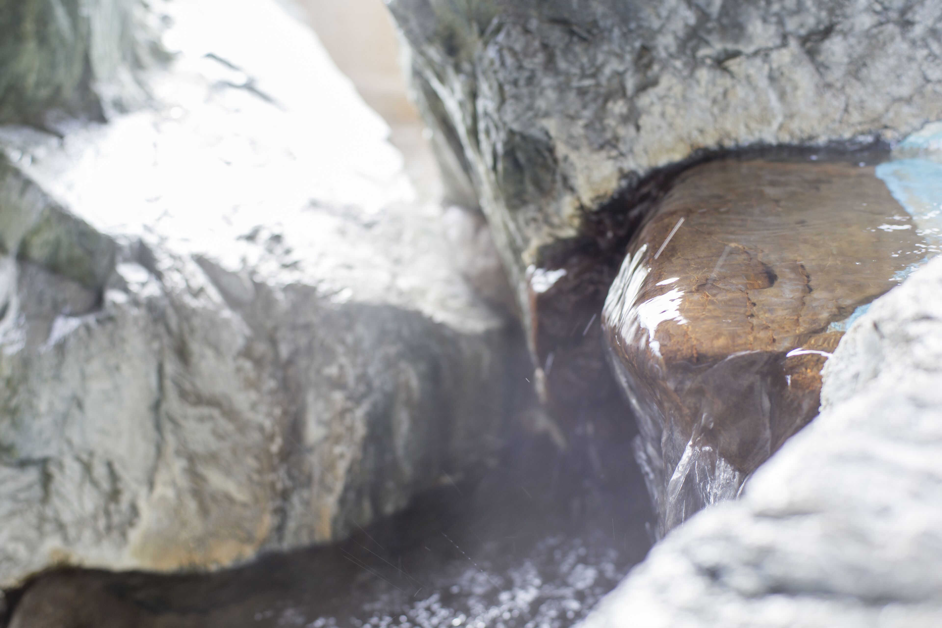 A close-up of a rock formation with water flowing over it.