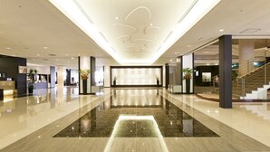 A spacious lobby with a polished marble floor, a reception desk, and a staircase leading to upper levels. - Grand Mercure Ise-shima Resort & Spa (Shima)