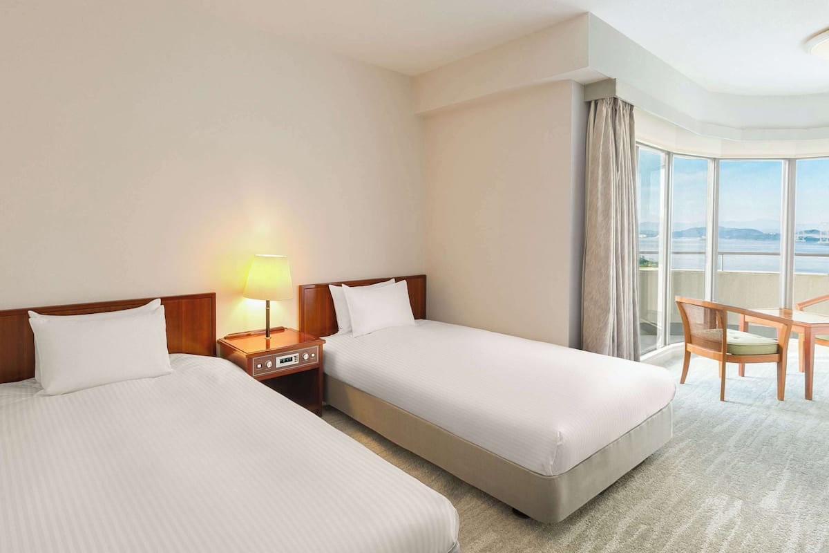 Enjoy a city view from the comfort of this stylish room, featuring two single beds and a cozy seating area.