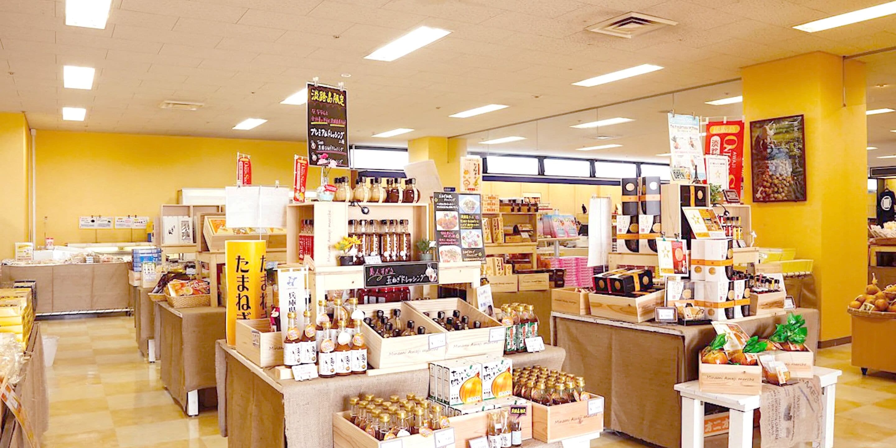 A store interior with shelves stocked with various products, including jars and boxes, and a counter area.