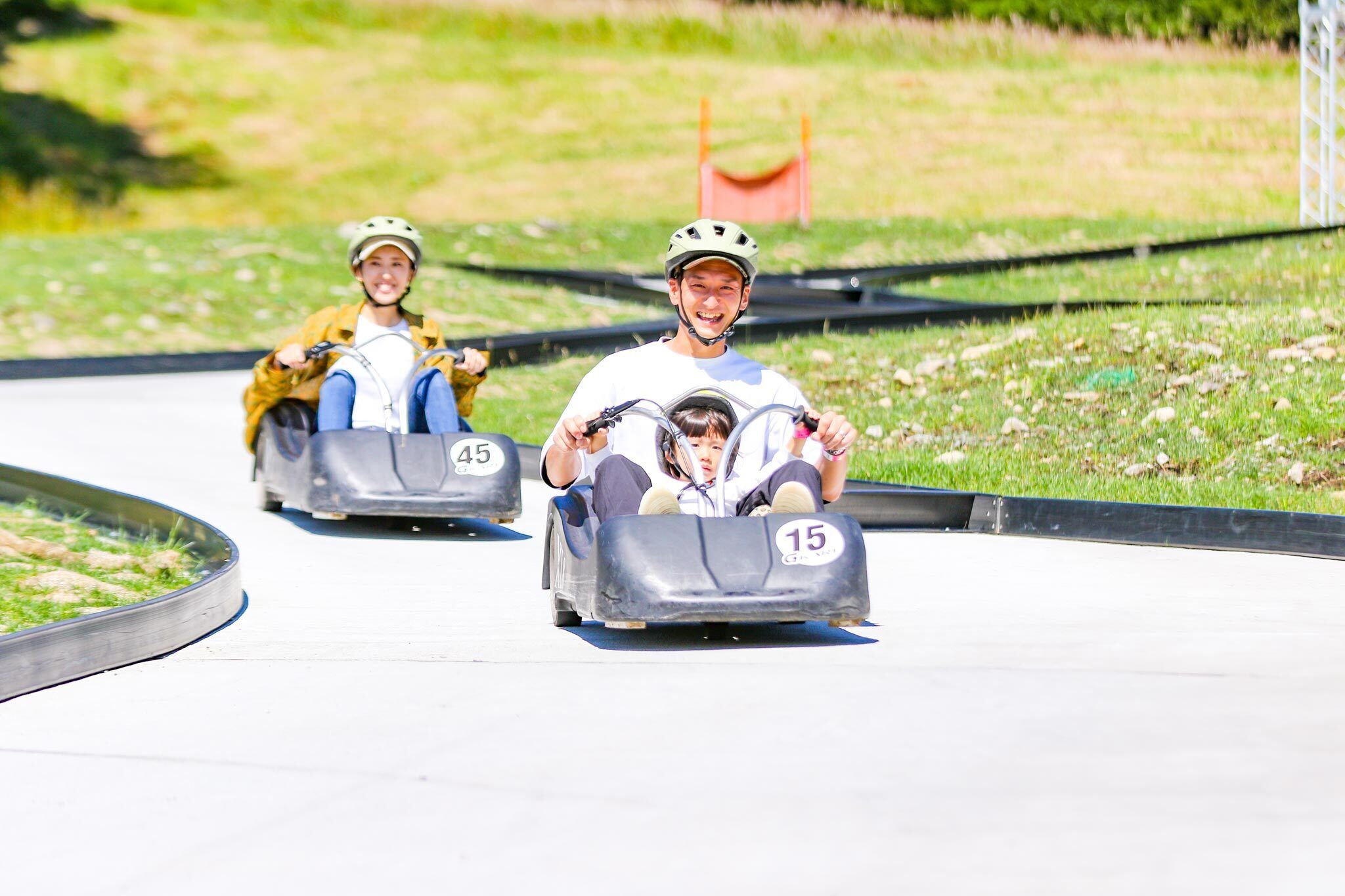 Two people in go-karts on a track.