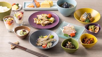 A variety of dishes arranged on a wooden table, including bowls, plates, and glasses.