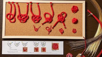 A corkboard with various red knots and a card with knot diagrams.