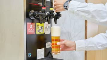 A person pouring beer into a glass from a tap.