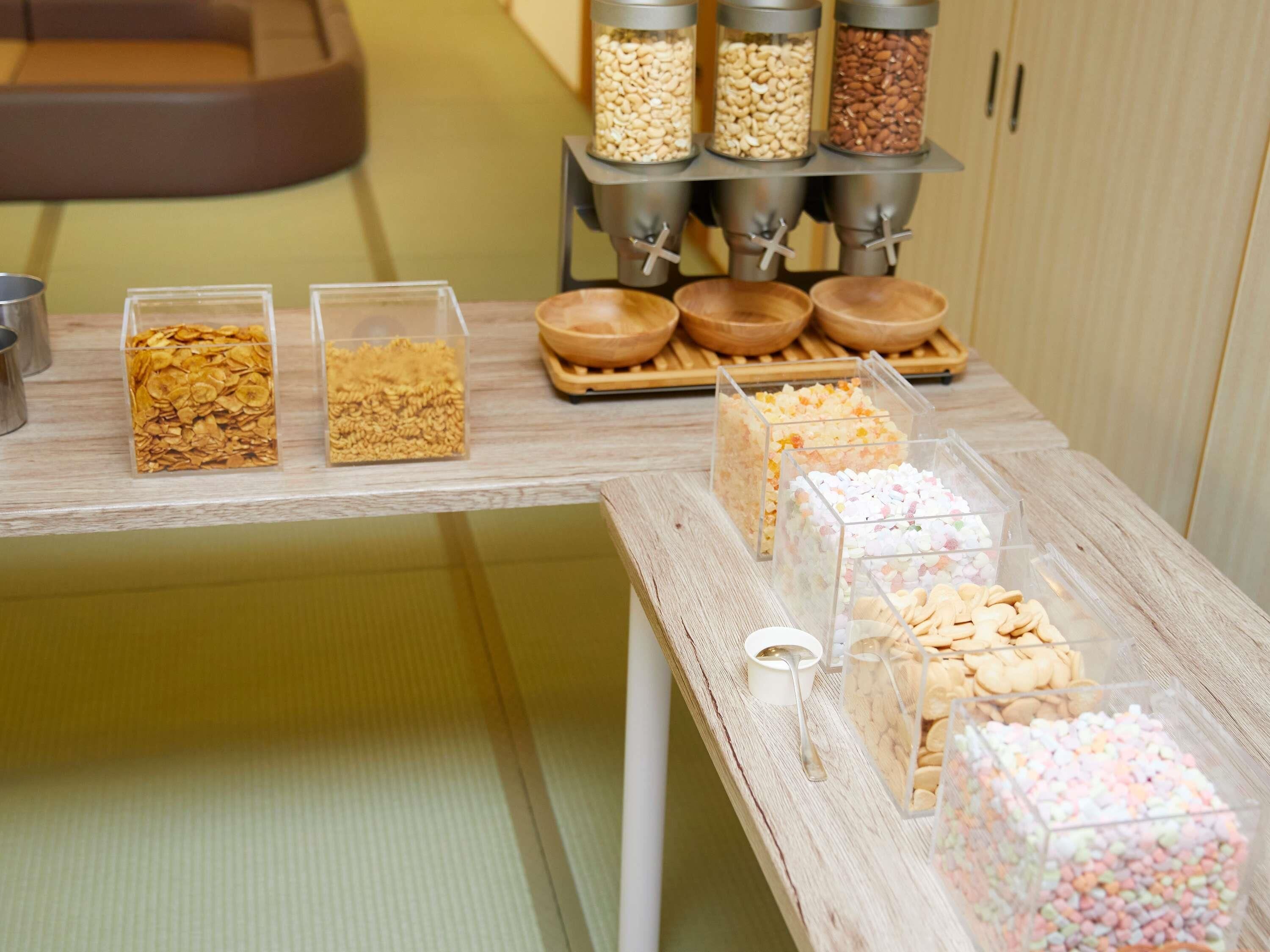A snack display with various food items in clear containers.