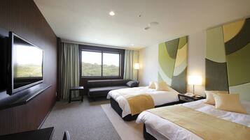 A hotel room with two beds, a TV, a sofa, and a large window with a view.