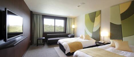 A hotel room with two beds, a TV, a sofa, and a large window with a view.
