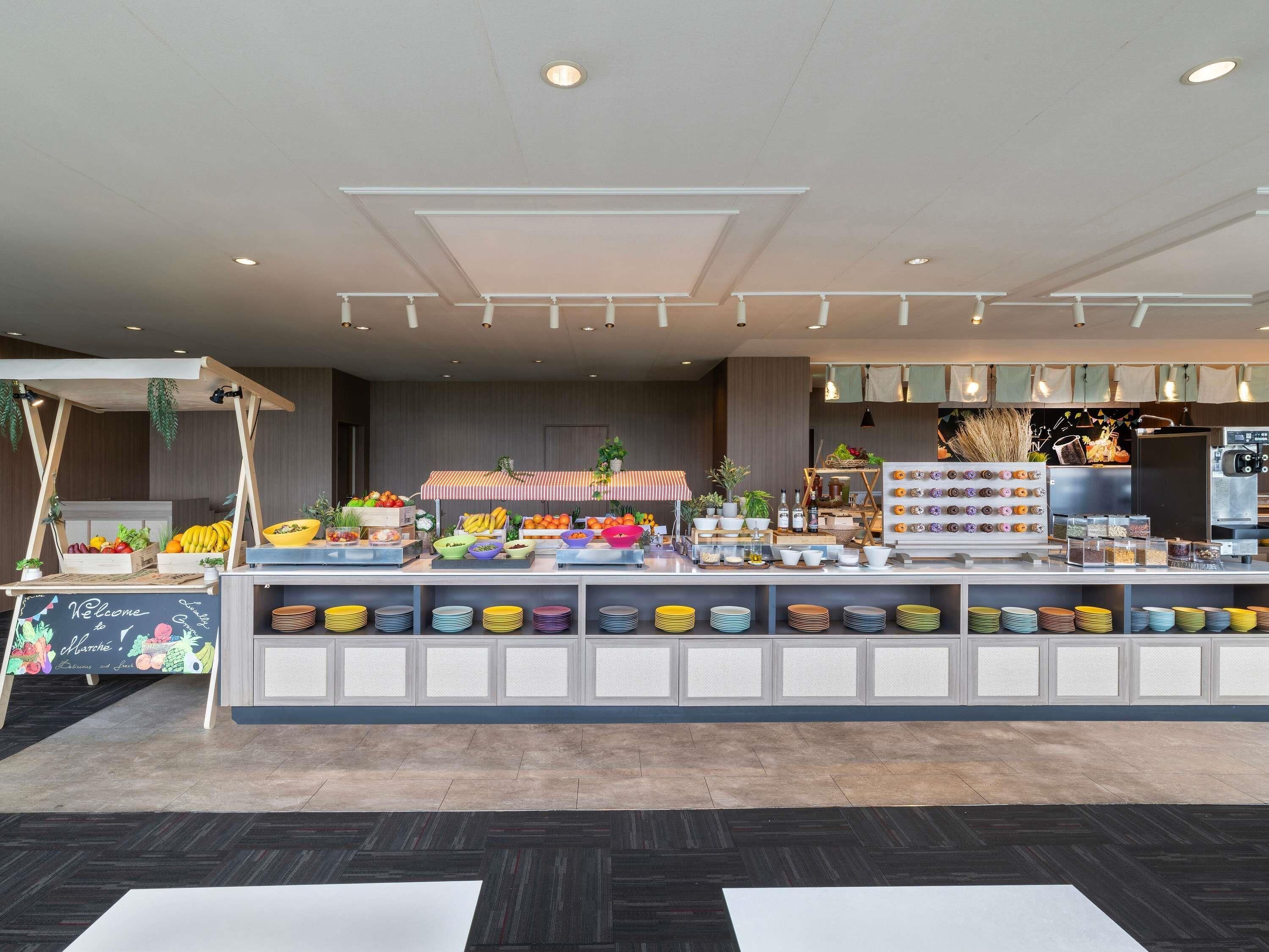 A buffet area with various food items and a coffee station.