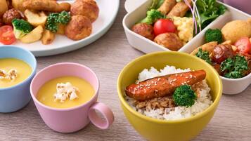 A variety of dishes including rice bowls, soup, and vegetables.
