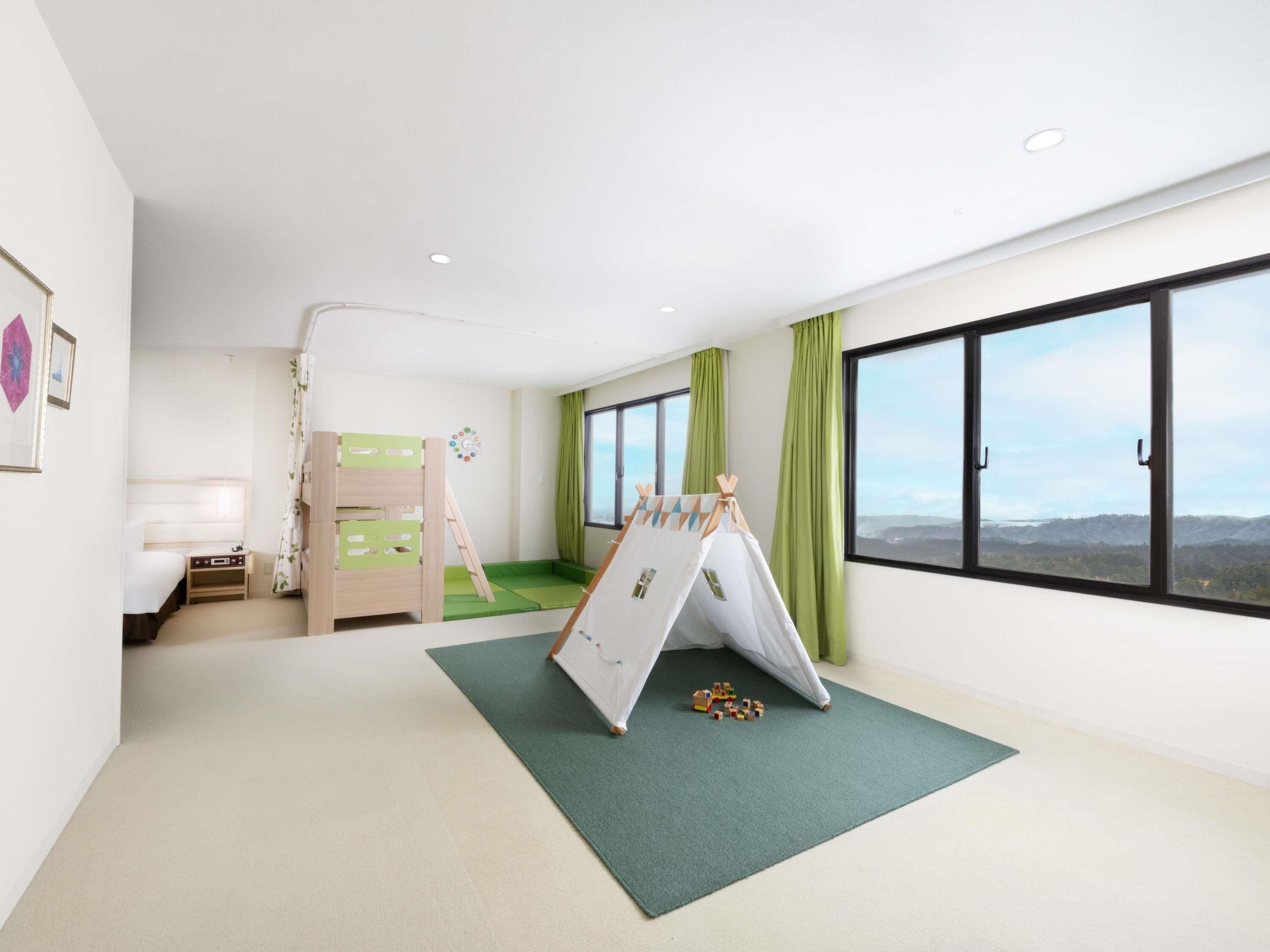 A child's room with bunk beds, a play tent, and a view of the outdoors.