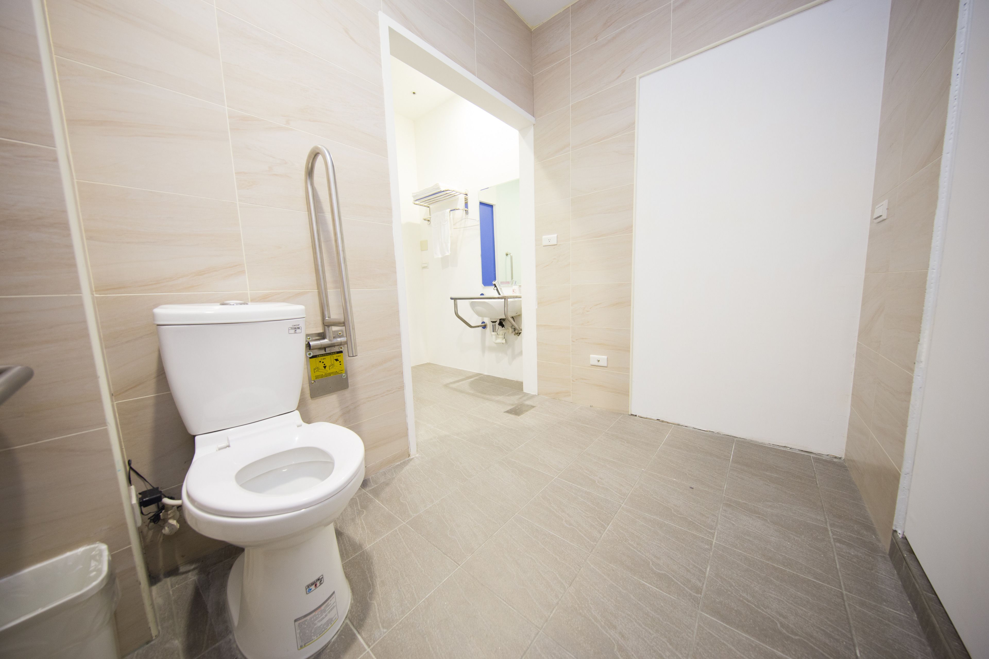 A modern bathroom with a toilet, a sink, and a shower area.