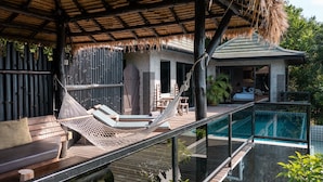 A wooden deck with a hammock, lounge chairs, and a pool. - Koh Tao Heights Pool Villas (Koh Tao)