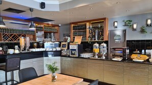 A restaurant with a bar area, seating, and a coffee machine. - Great Southern Hotel Perth (Perth)