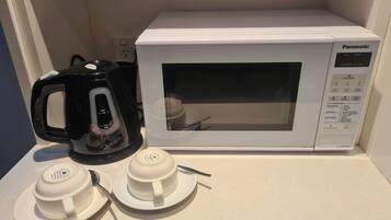 A white Panasonic microwave oven on a countertop.