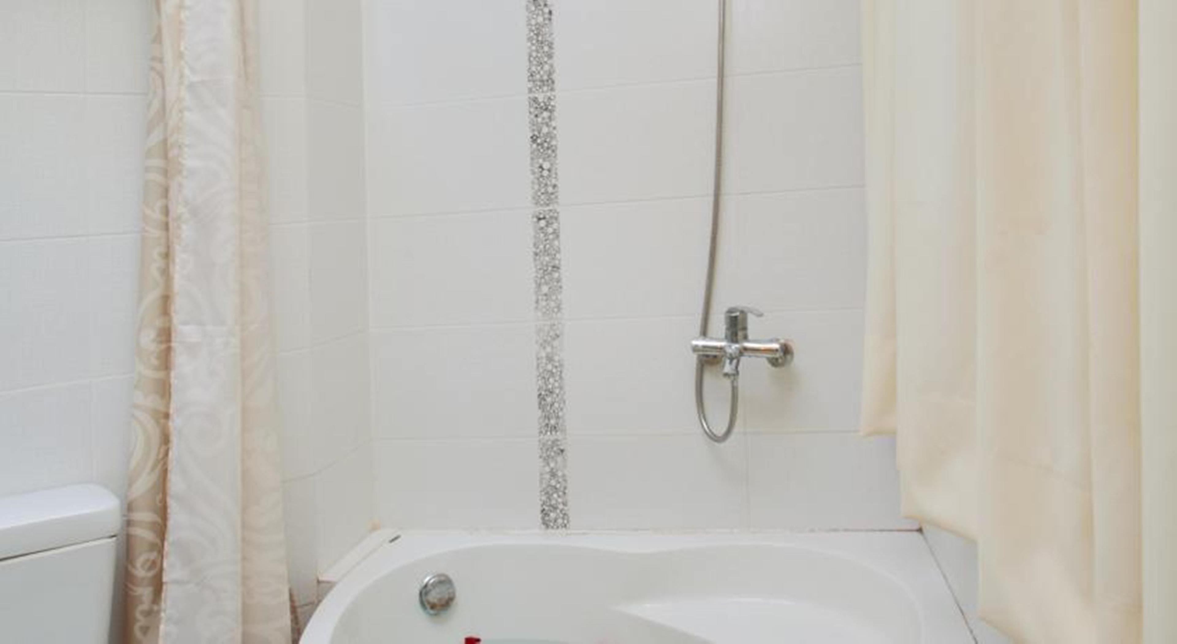 A bathroom with a bathtub, a shower, and a toilet.