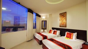 A hotel room with two beds, a large window with curtains, a mirror, and a painting on the wall. - Kim Yen Hotel (Ho Chi Minh City)