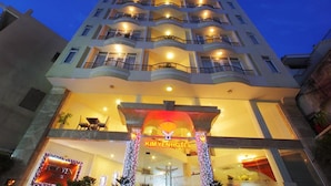 A multi-story hotel with a prominent entrance, balconies on each floor, and a well-lit facade. - Kim Yen Hotel (Ho Chi Minh City)