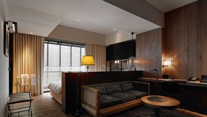 A modern hotel room with a bed, a sofa, a desk, and a small round table. - Hotel Proverbs Taipei (Taipei)
