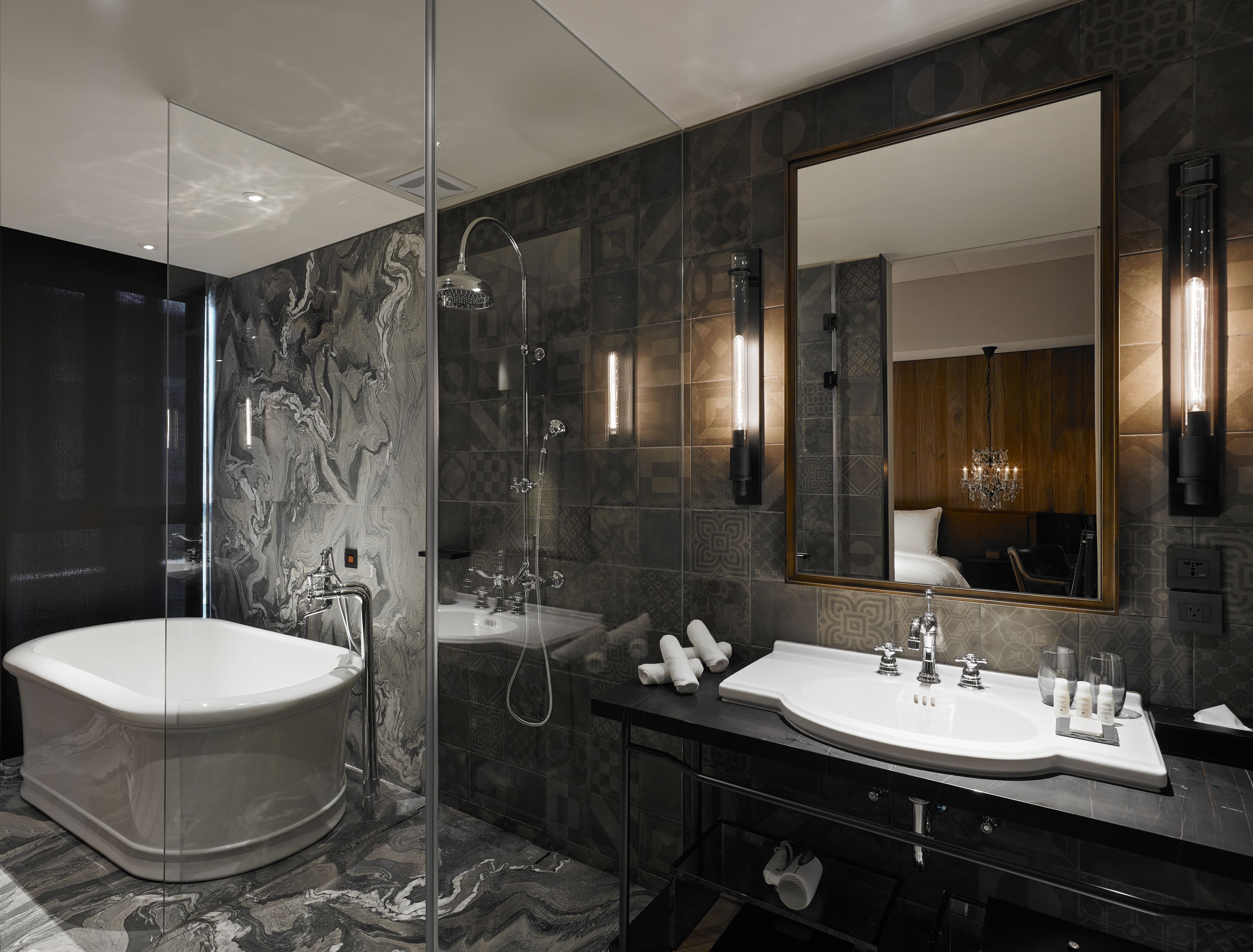 A modern bathroom with a freestanding bathtub, a vanity with a large mirror, and a shower enclosure.