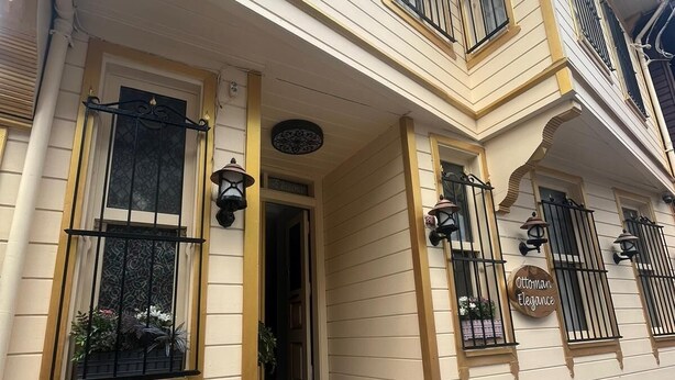 A two-story building with a beige facade, a brick fireplace, and a sign reading "Ottoman Elegance". - Ottoman Elegance Hotel (Istanbul)