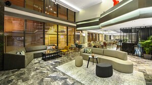 A spacious lobby with a large seating area, a dining section, and a staircase leading to upper floors. - Arts Hotel Istanbul - Special Class (Istanbul)